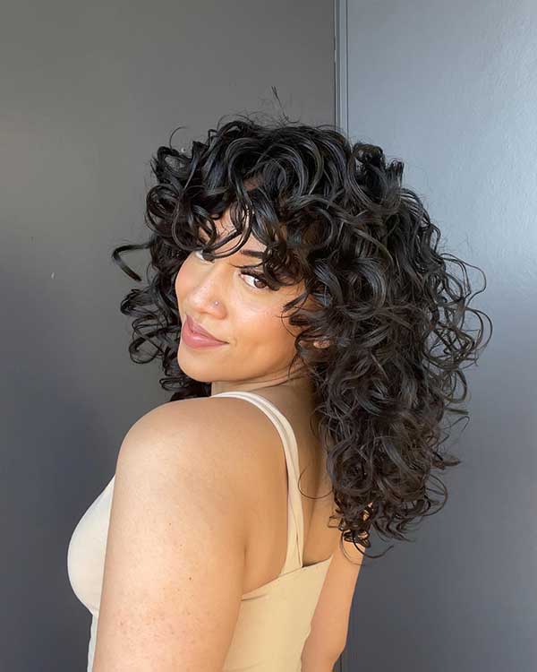 Medium Curly Hair With Bangs And Layers